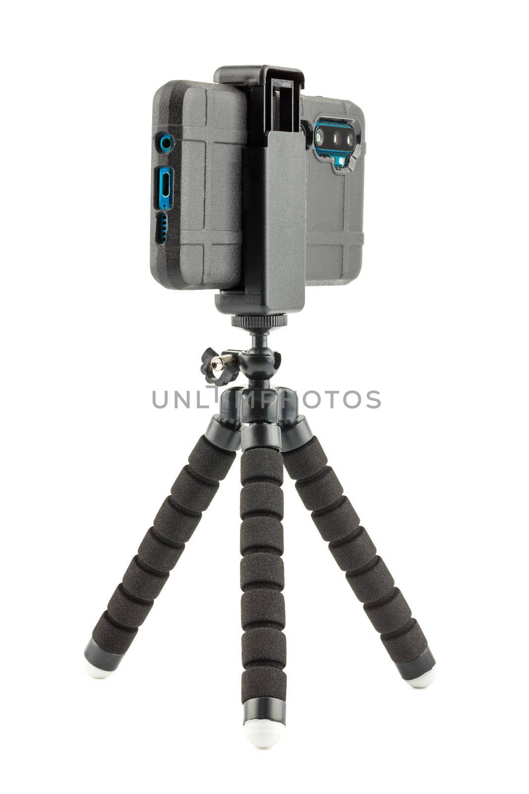 black cellphone in rugged rubber protective cover on small flexible tripod isolated on white background