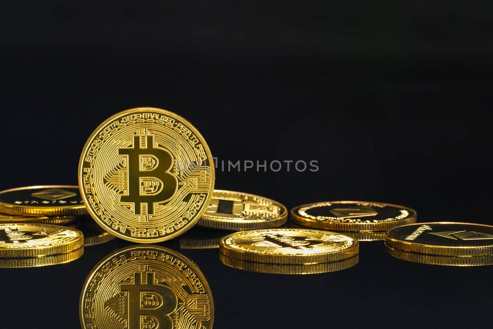 Golden coins with Bitcoin cryptocurrency symbol on black  by stoonn