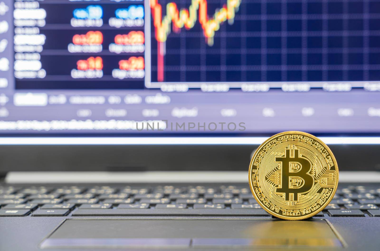 Bitcoins coin on keyboard computer. Close up of  bitcoin crypto currency coins with trading exchange market price chart in the background