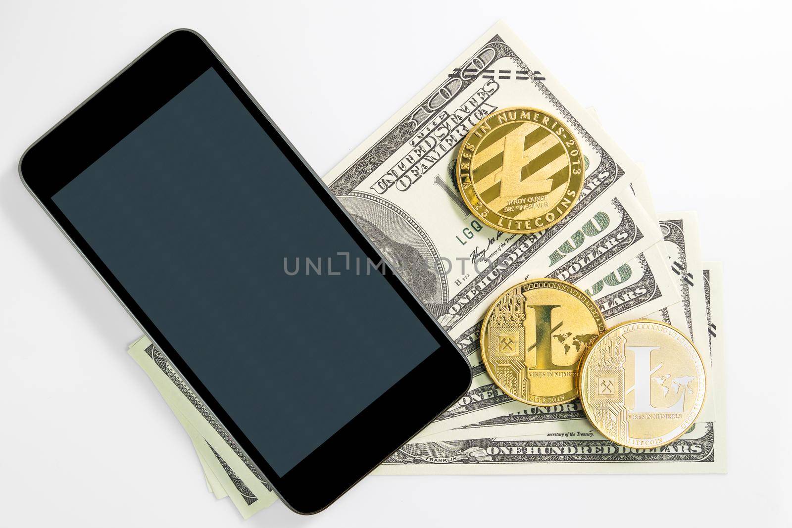 Litecoins coin and  US banknotes of one hundred dollars with smartphone mockup. Close up of metal shiny Litecoin crypto currency coins and US dollar