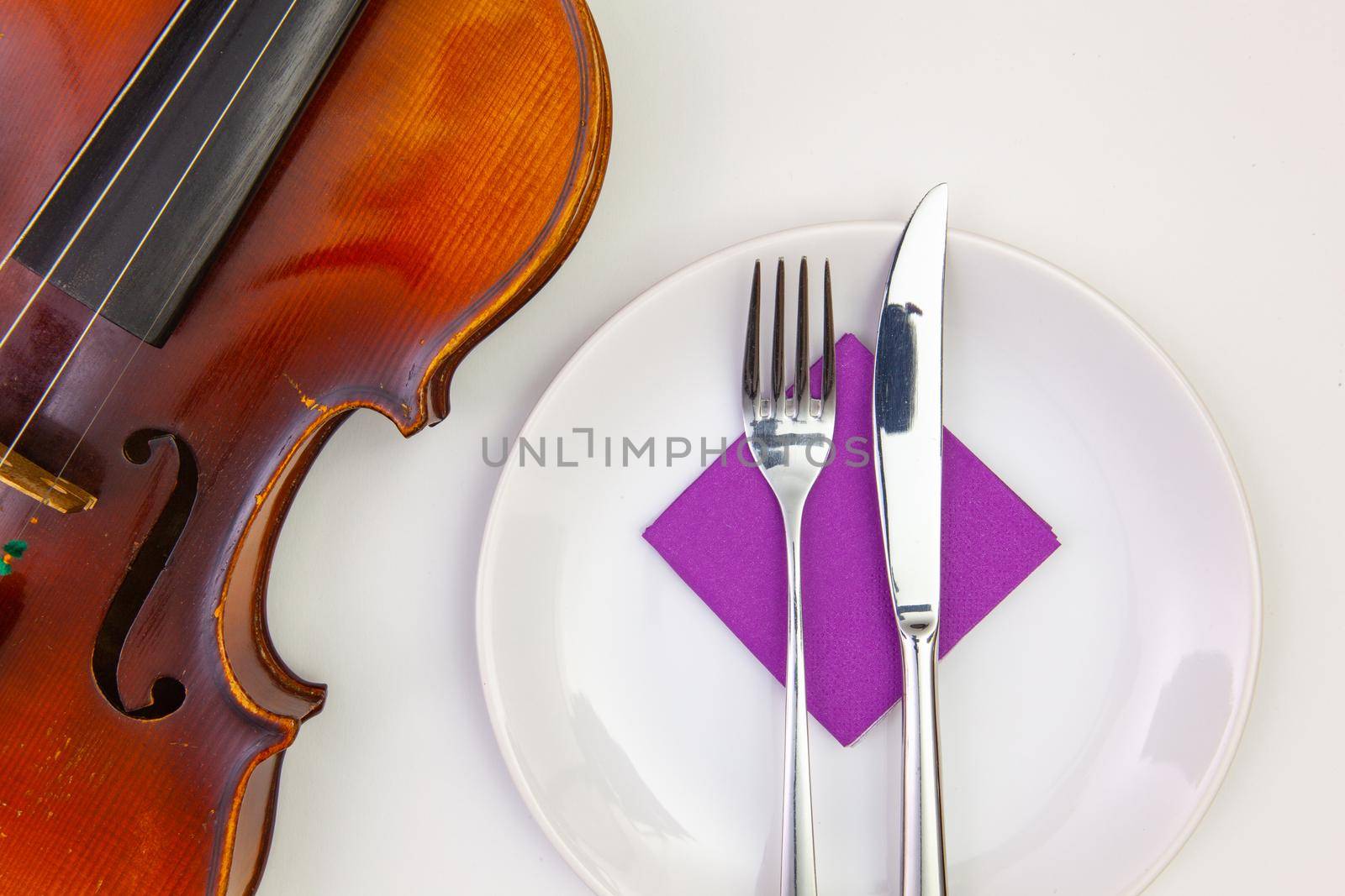 White plate and old violin on the white  wooden table. by CaptureLight