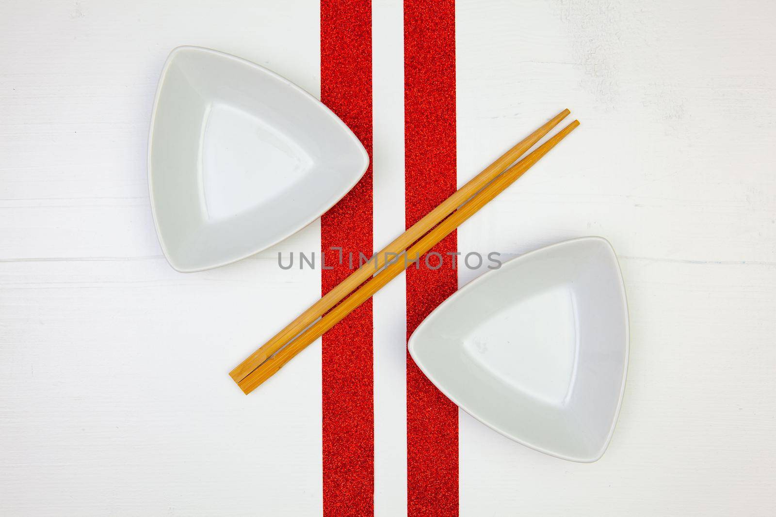 Ceramic bowls  and bamboo chopsticks for sushi food with on the white wooden table.Top view. Flat Lay Image.