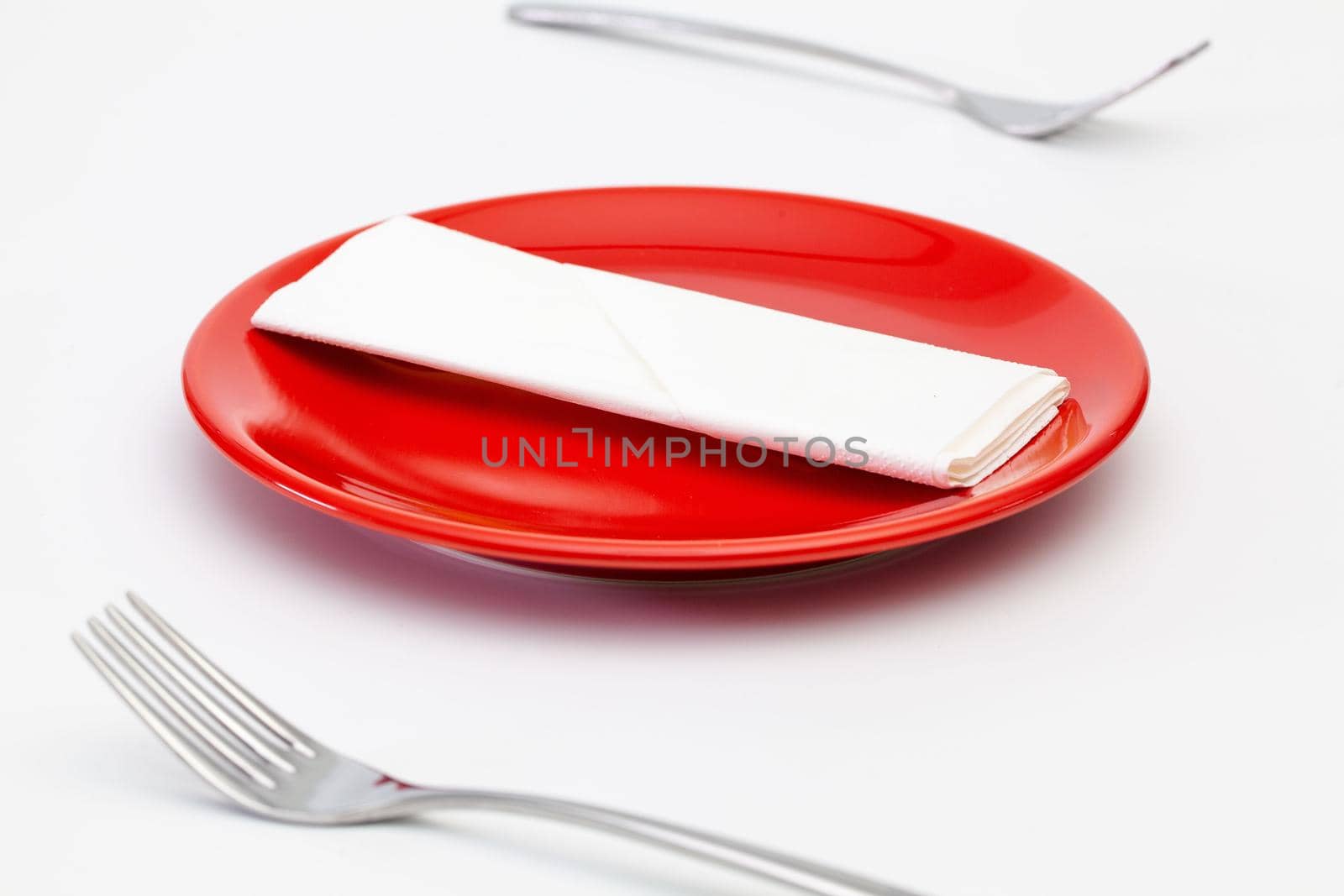 Red plate and on the white wooden table.Top view. Flat Lay Image.