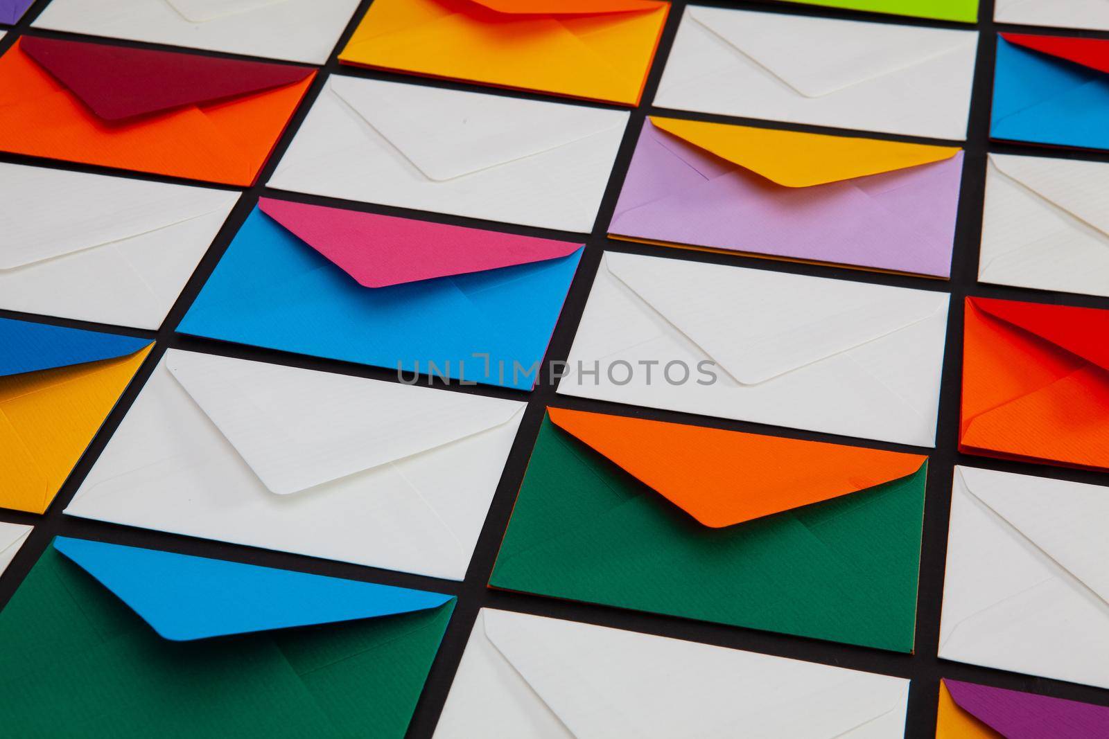 Composition with white and colored envelopes on the table. The photo suitable for various holidays and anniversaries.