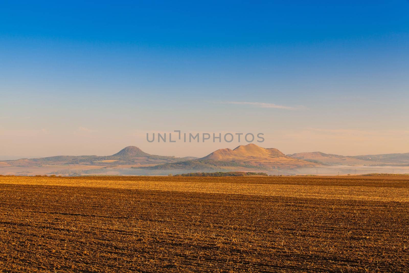 Autumn landscape with agricultural land, recently plowed and prepared for the crop.Central Bohemian Upland, Czech Republic. Panorama picture.