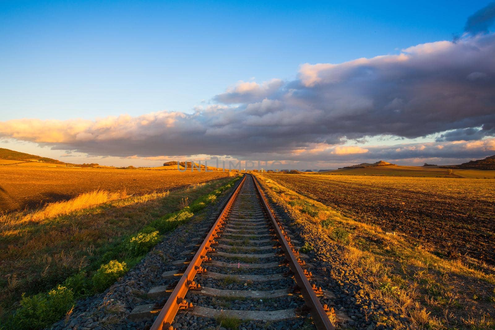 Single railway track at sunset, Central Bohemian Uplands, Czech Republic. Railway track in nature park Central Bohemian Highlands, Czech Republic
