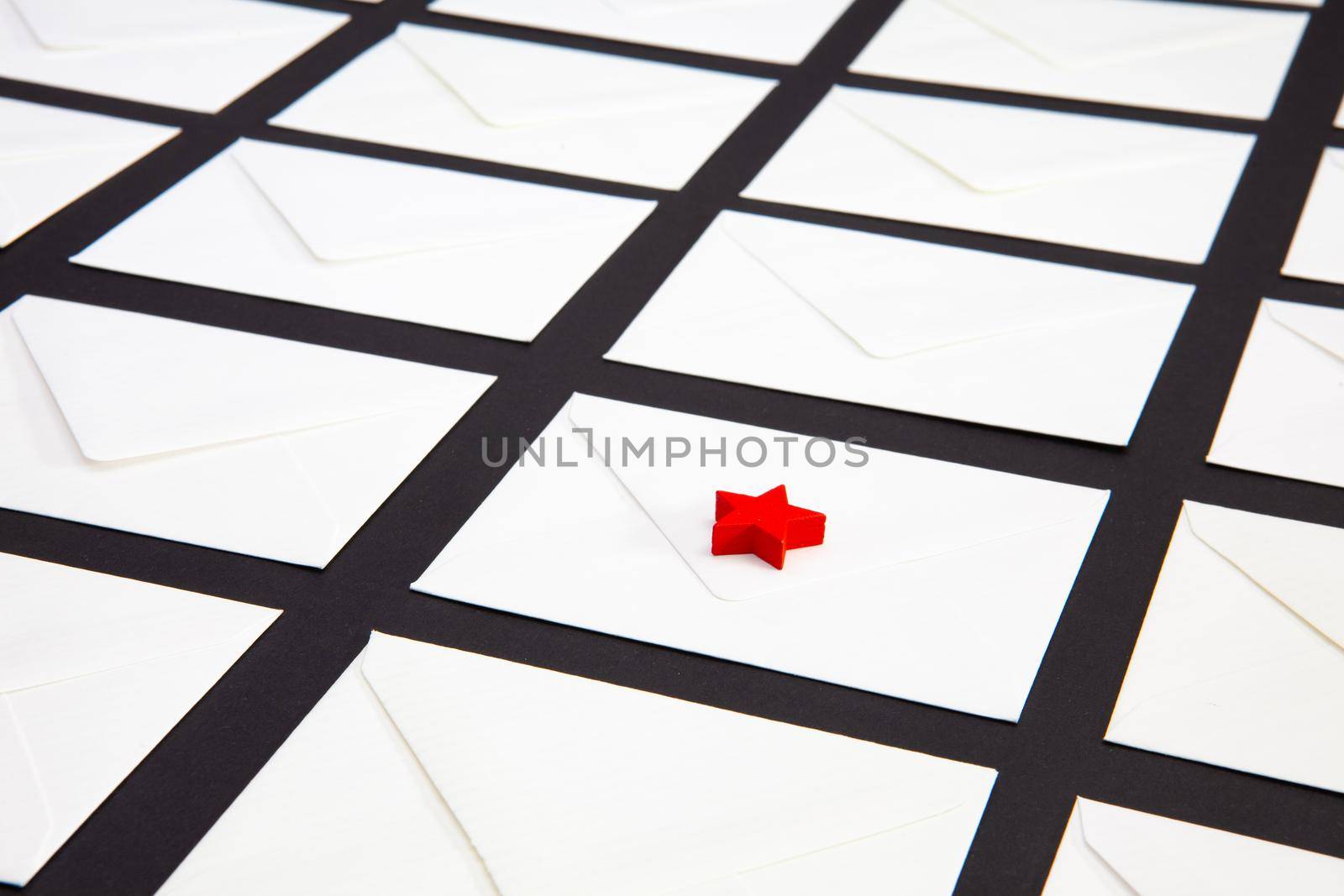 Composition with white envelopes and red star on the table. The photo suitable for various holidays and anniversaries.