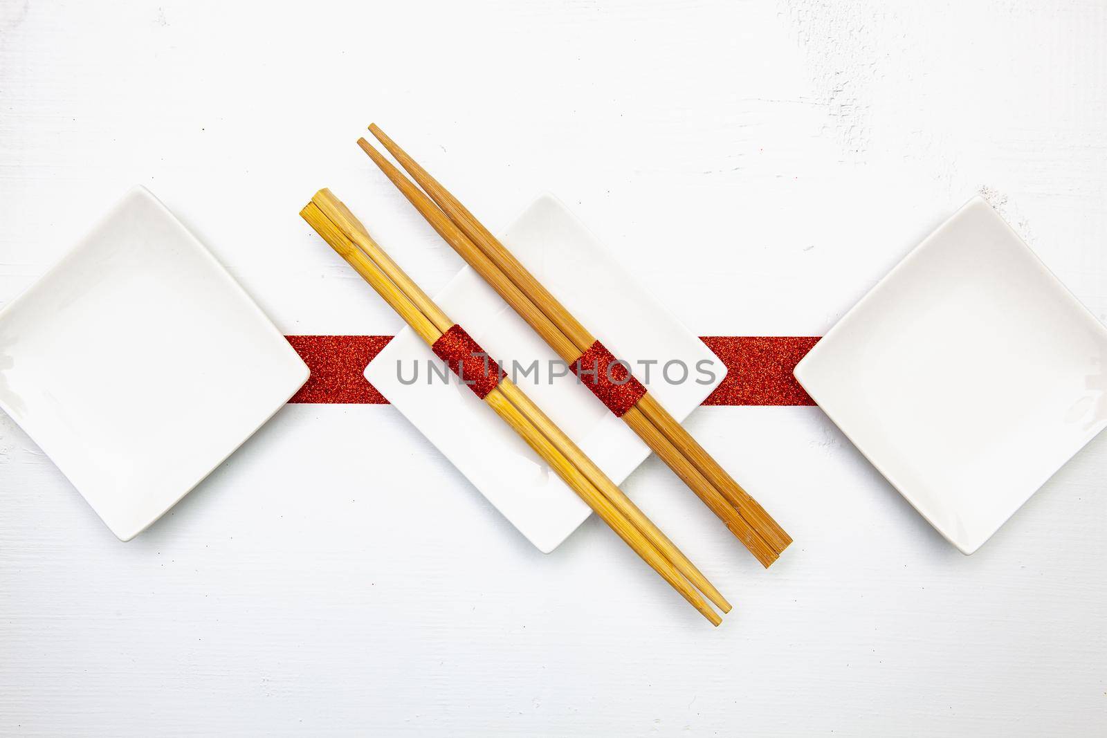Ceramic bowls  and bamboo chopsticks for sushi food . by CaptureLight