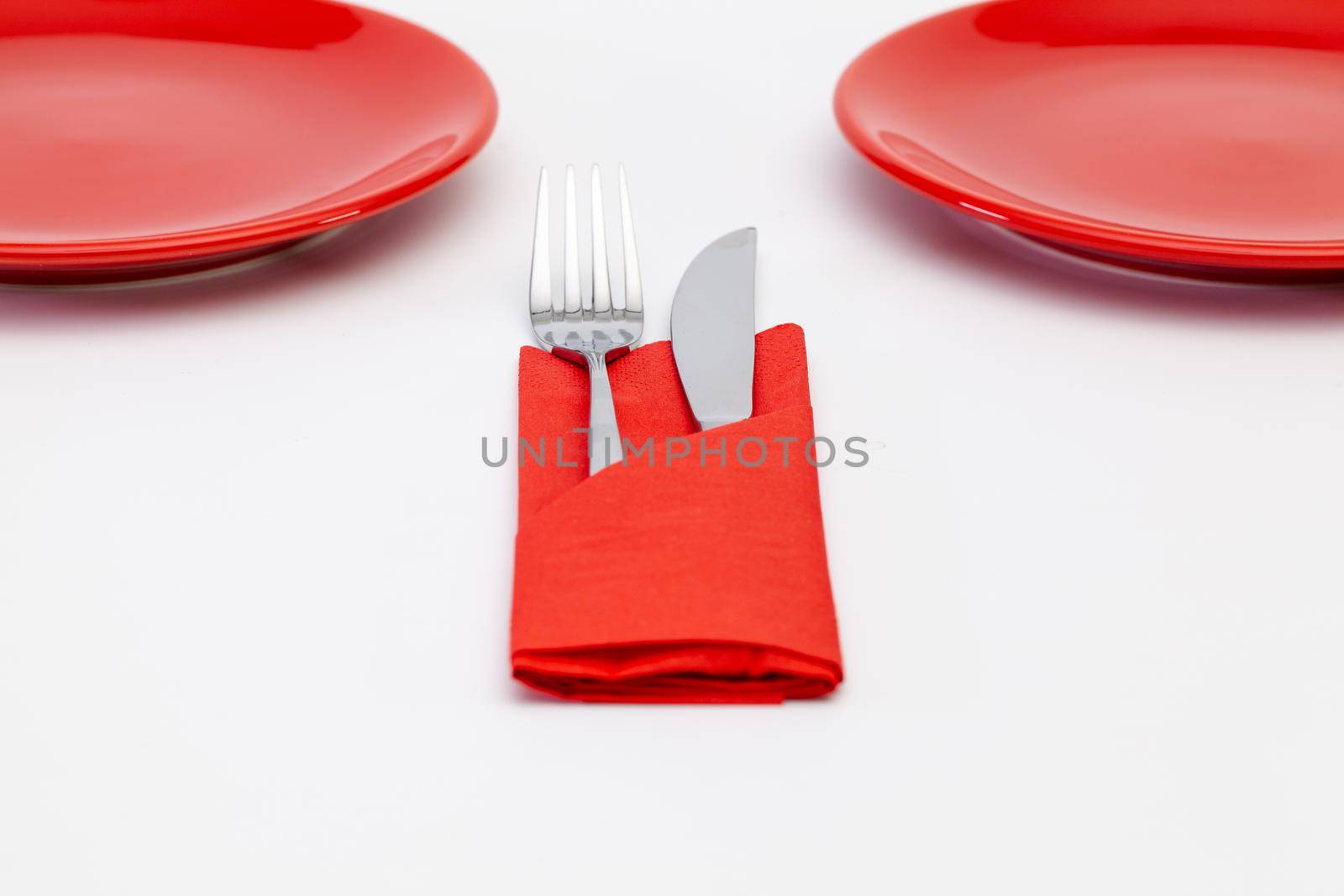 Red plates on the white wooden table.Top view. Flat Lay Image.