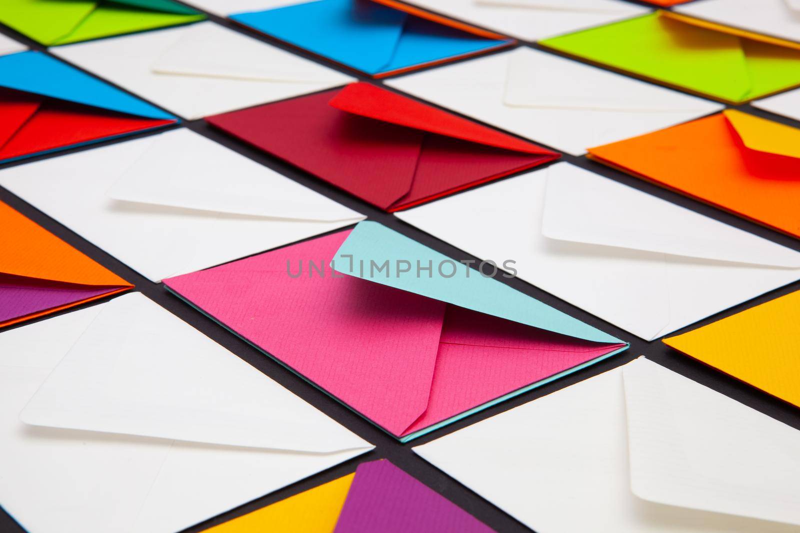 Composition with white and colored envelopes on the table.  by CaptureLight