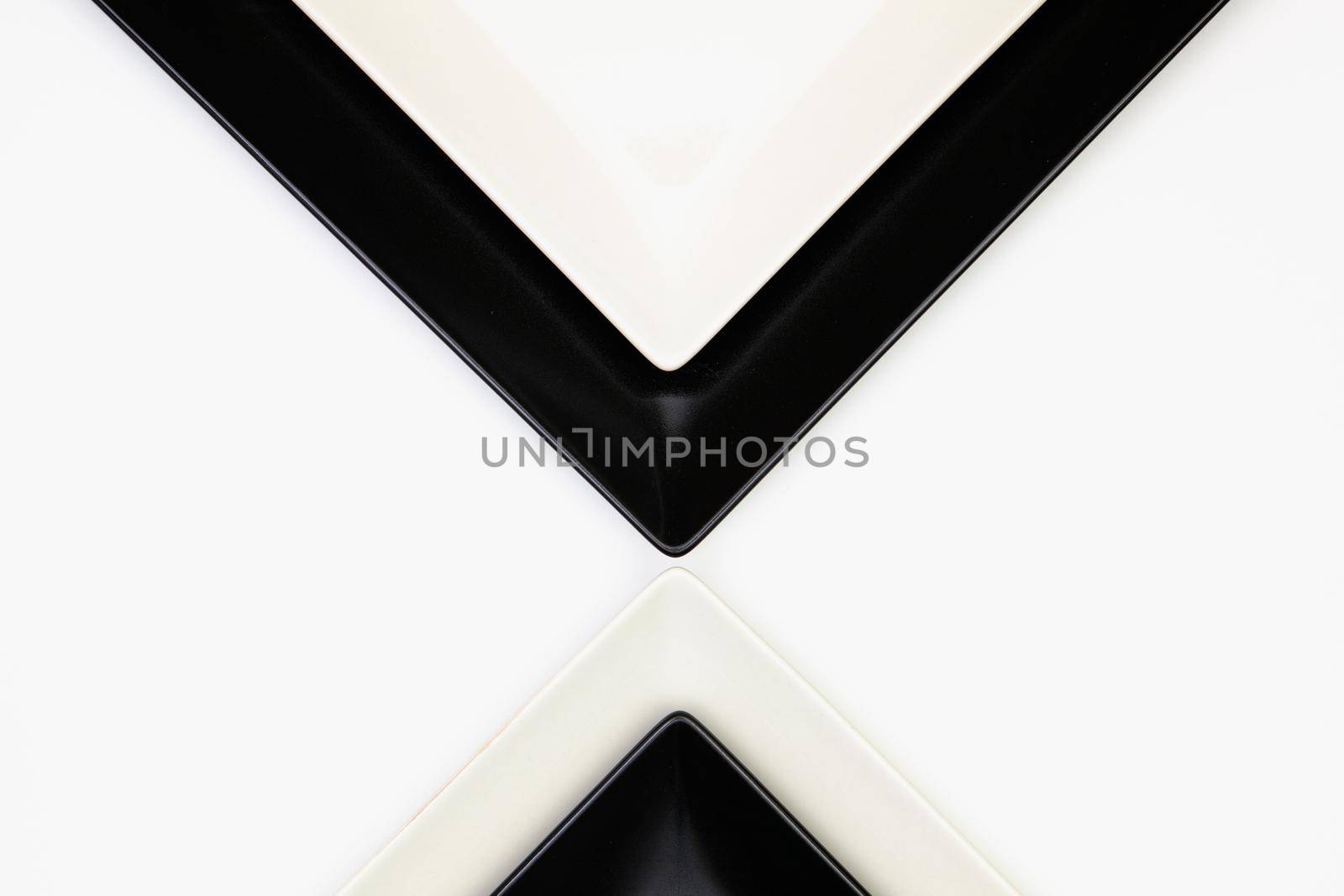 Different  black and white plates on the white table.Top view. Flat Lay Image.
