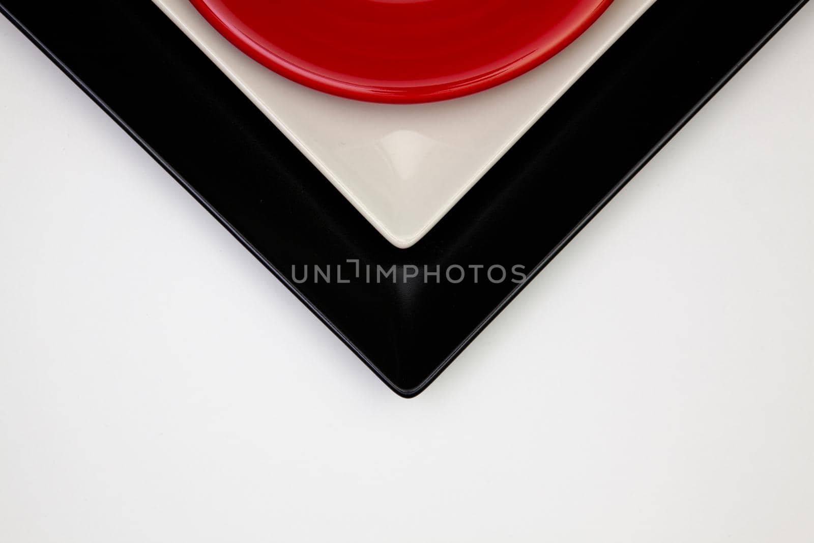 Different  plates on the white table.Top view.  by CaptureLight