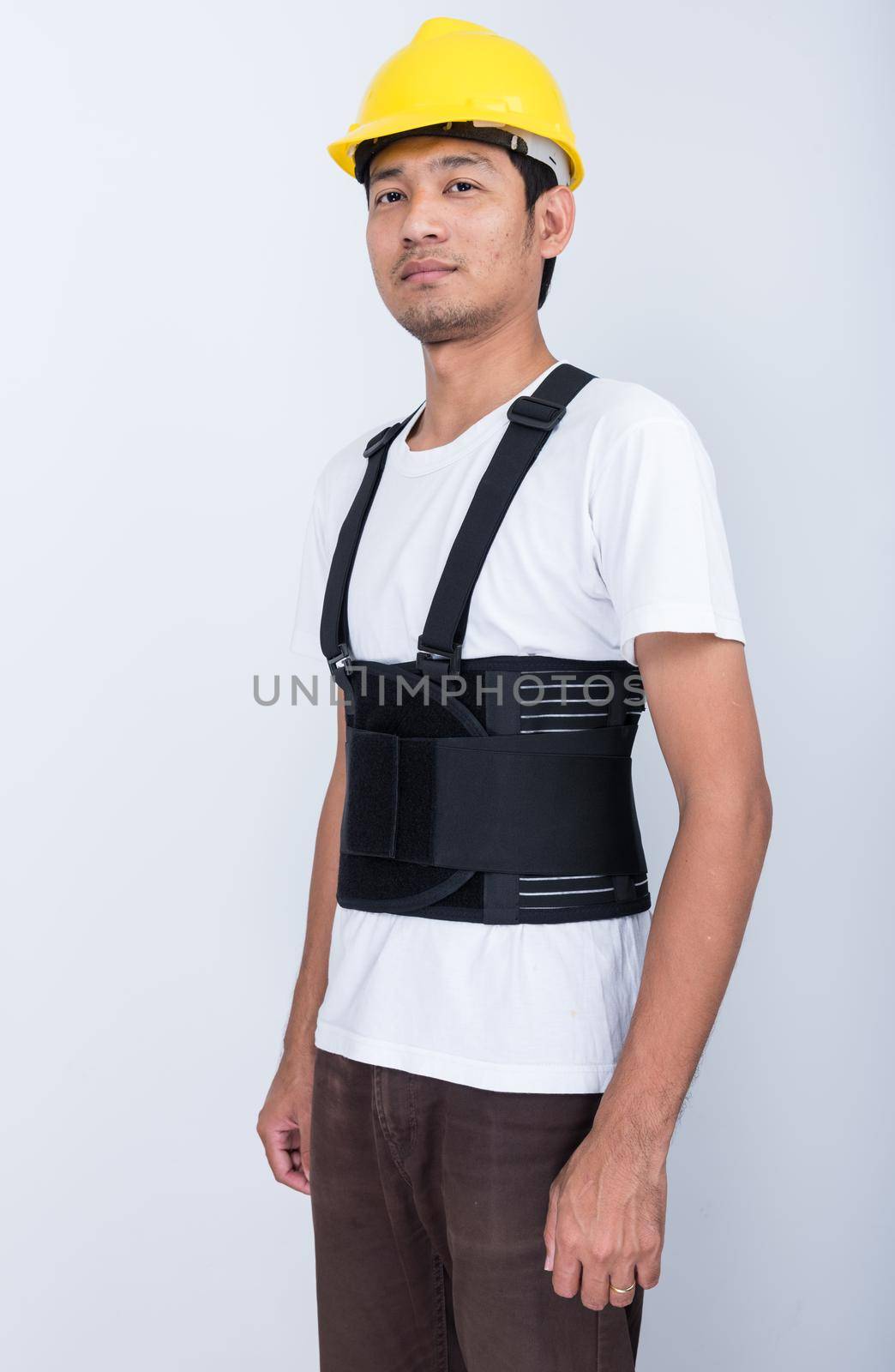 Worker Man stand wearing back support belt body protect posture