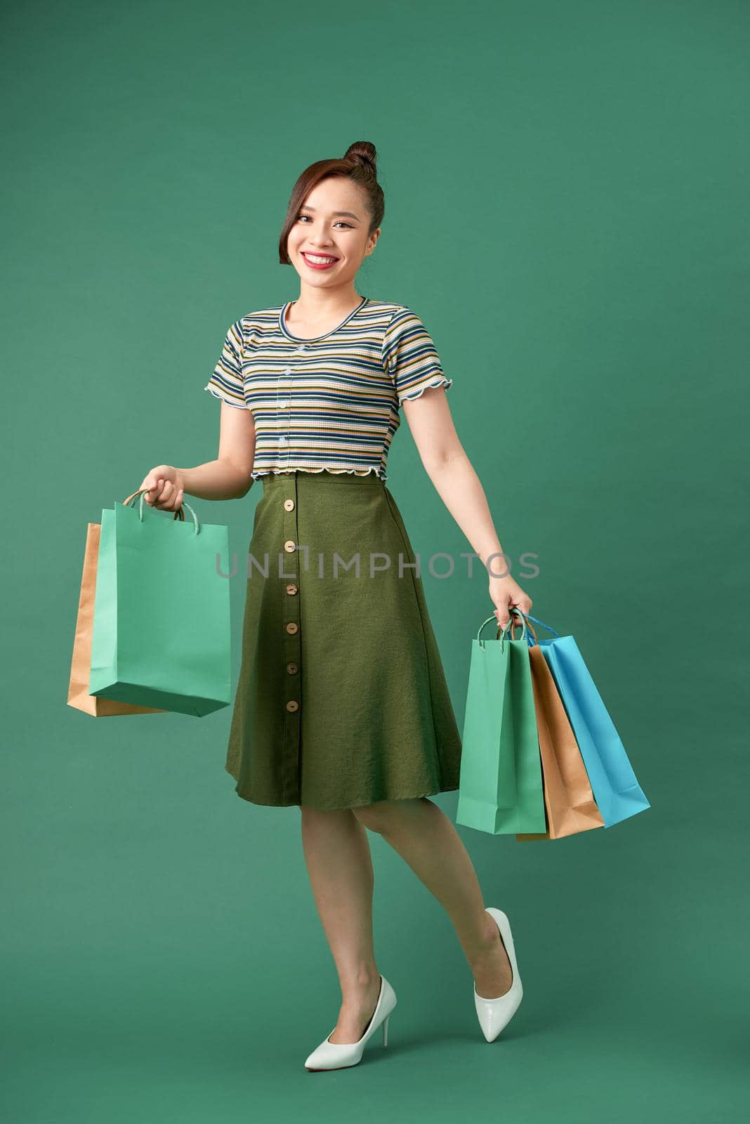Woman shopaholic with multi-colored packages in hand