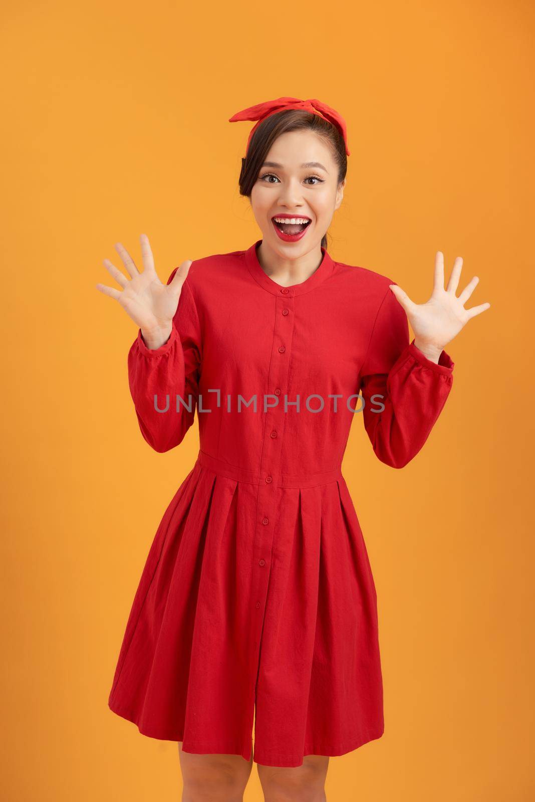 Beautiful Elegant young Woman happy cheering in red dress - playful and cheerful by makidotvn