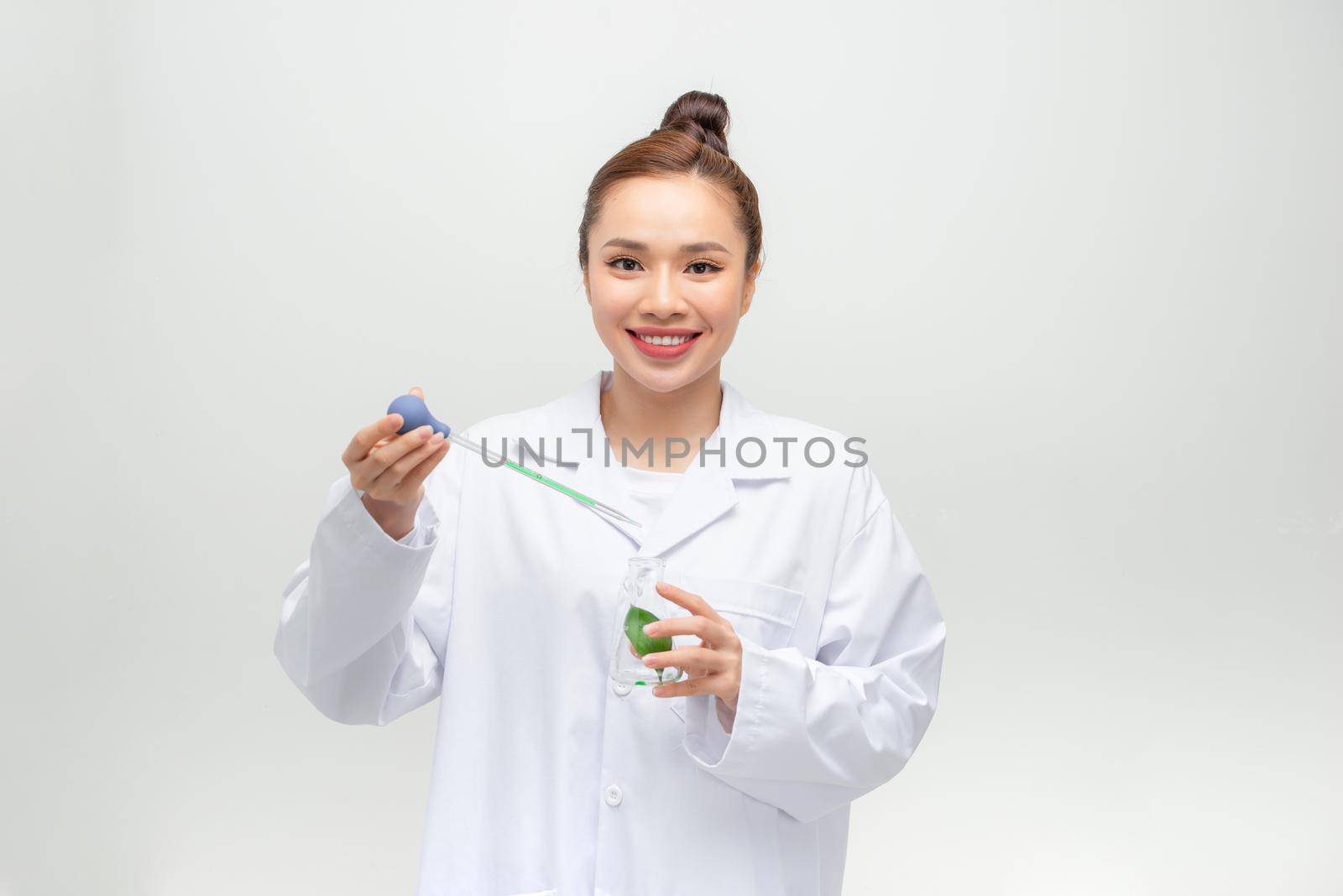 Scientist in uniform holding beaker and test tube have chemical liquid for testing chemical reaction.