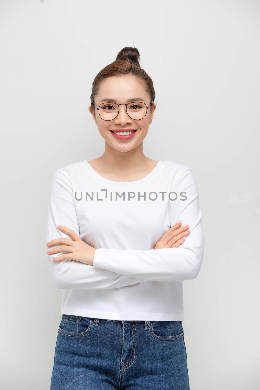 Confident woman with arms crossed - isolated over a white background