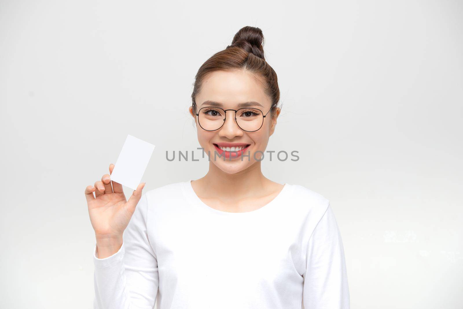Young Asian woman point to a blank card on white background by makidotvn