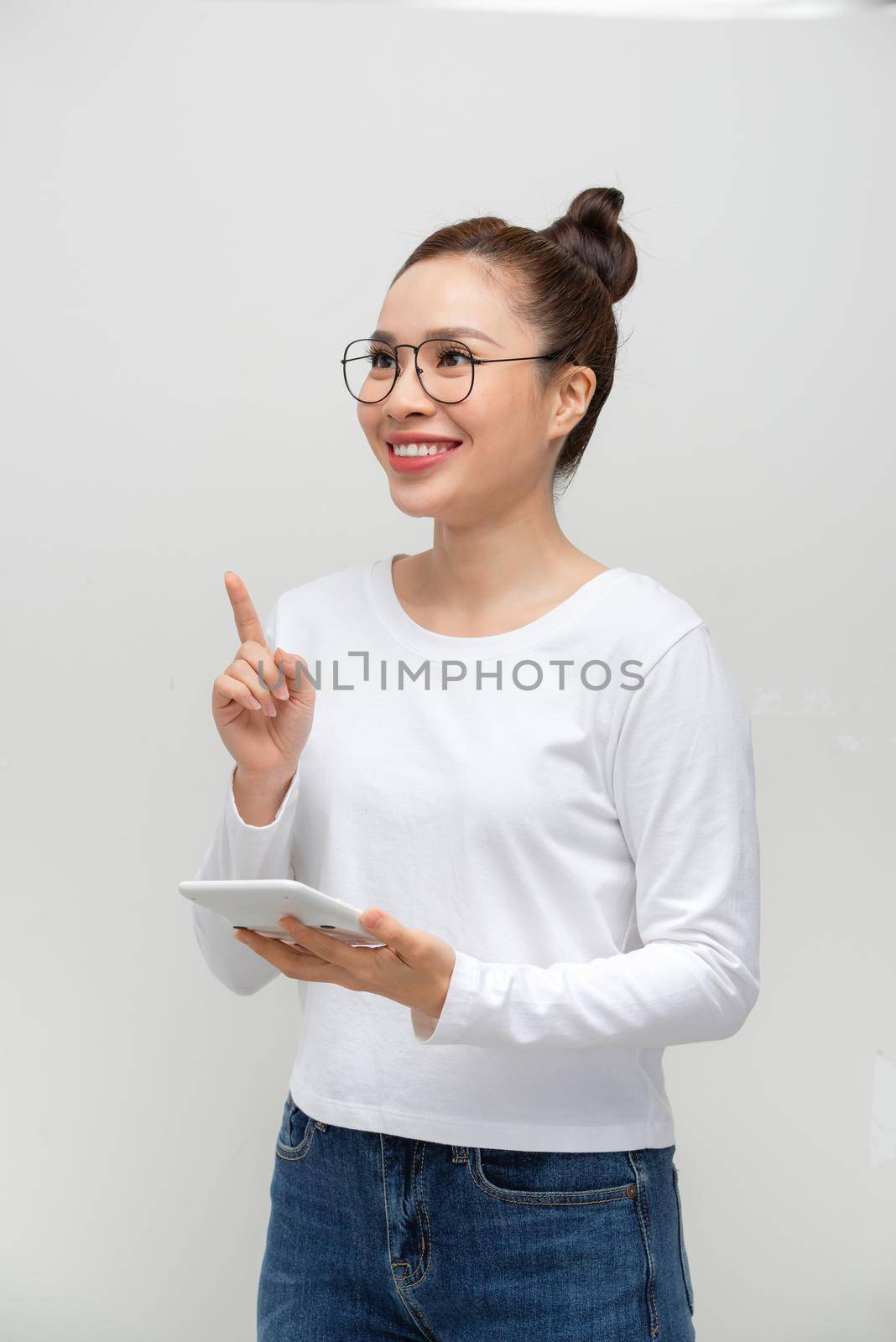portrait of young asian woman using calculator isolated on white background