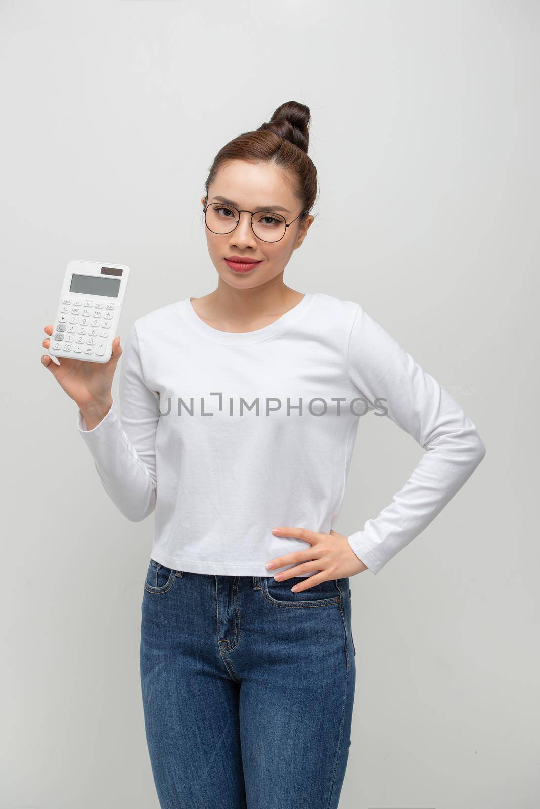 Dissatisfied young business woman in white shirt posing isolated on white background  by makidotvn
