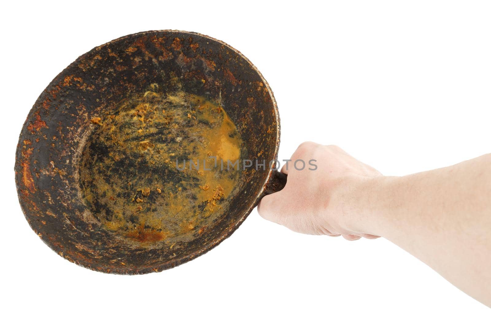 bare caucasian hand holding empty old cast iron frying pan - isolated on white background