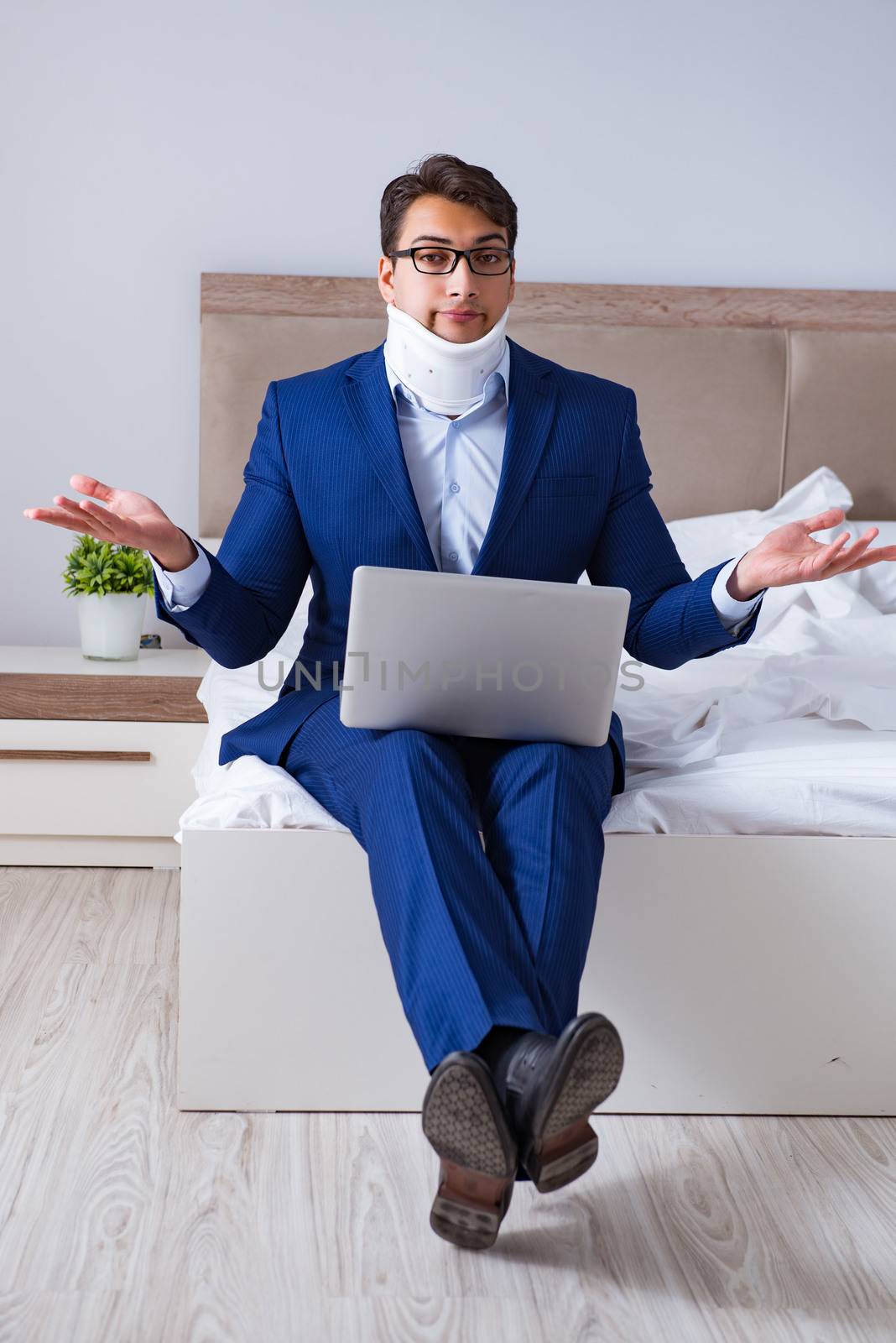 Businessman with neck injury working from home