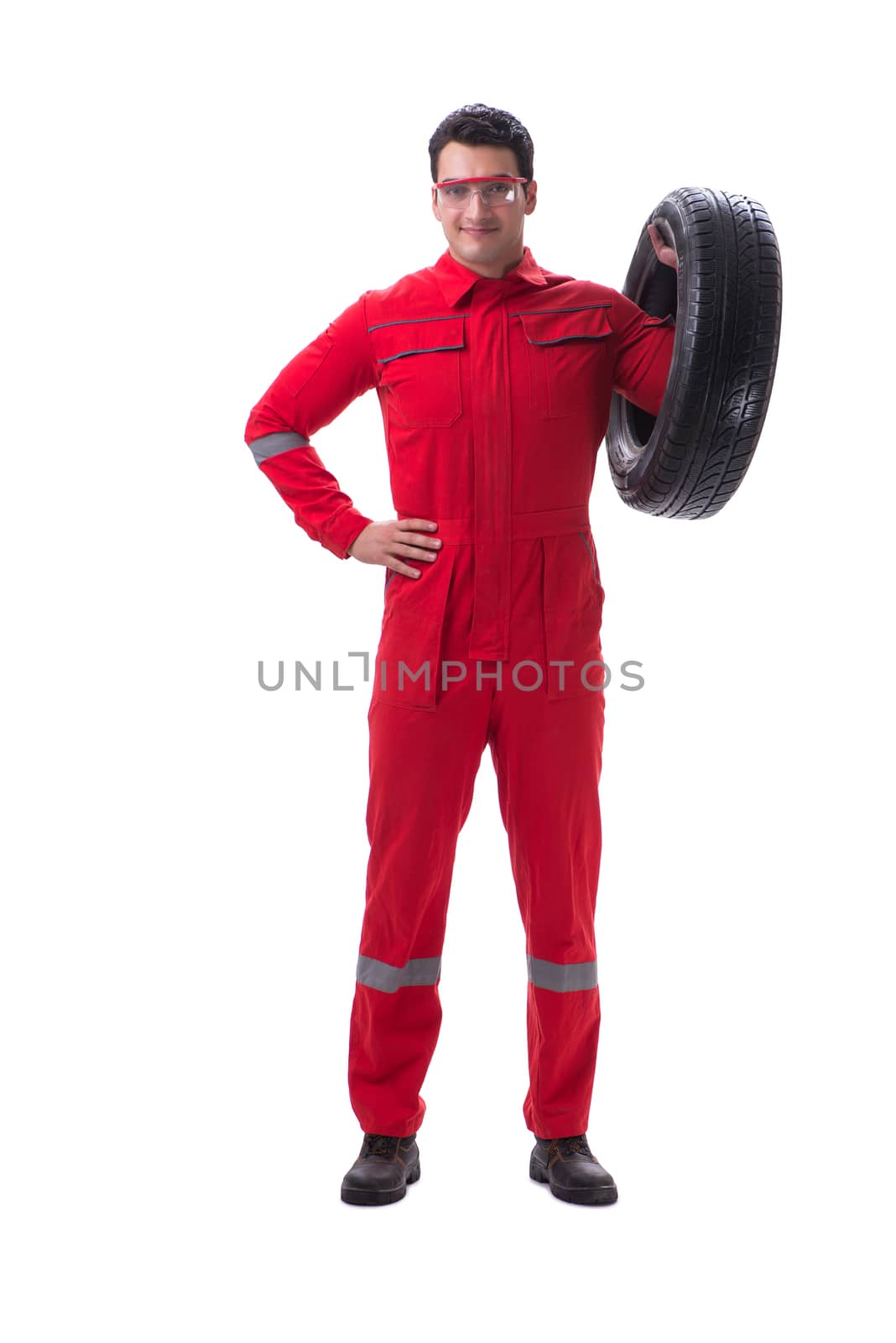 Young tyre repairman in red coveralls isolated on white background