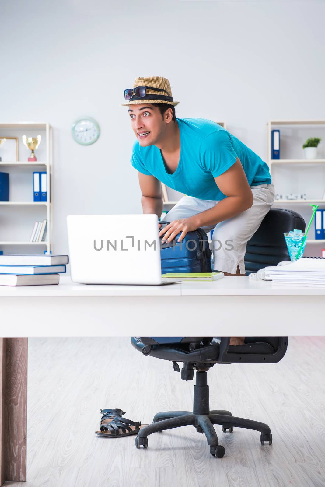 Businessman preparing for vacation in the office