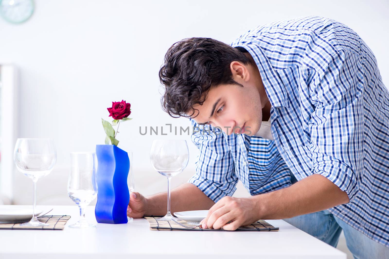 Man alone preparing for romantic date with his sweetheart