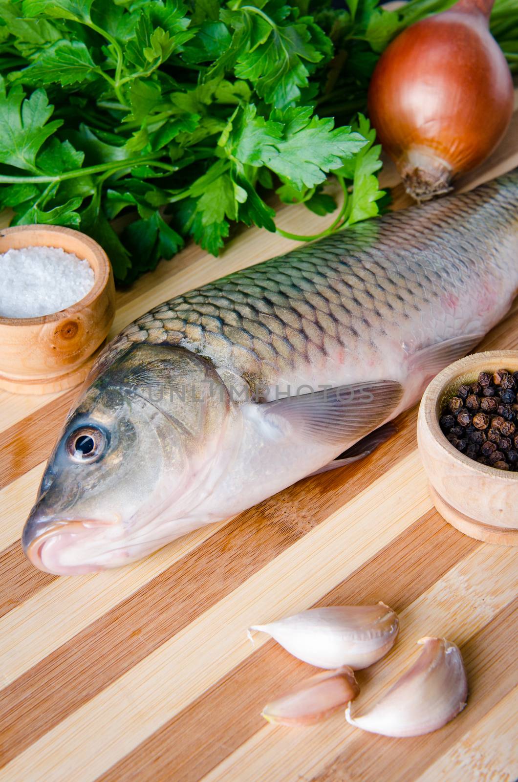 Uncooked fish on cutting board in meal preparation concept