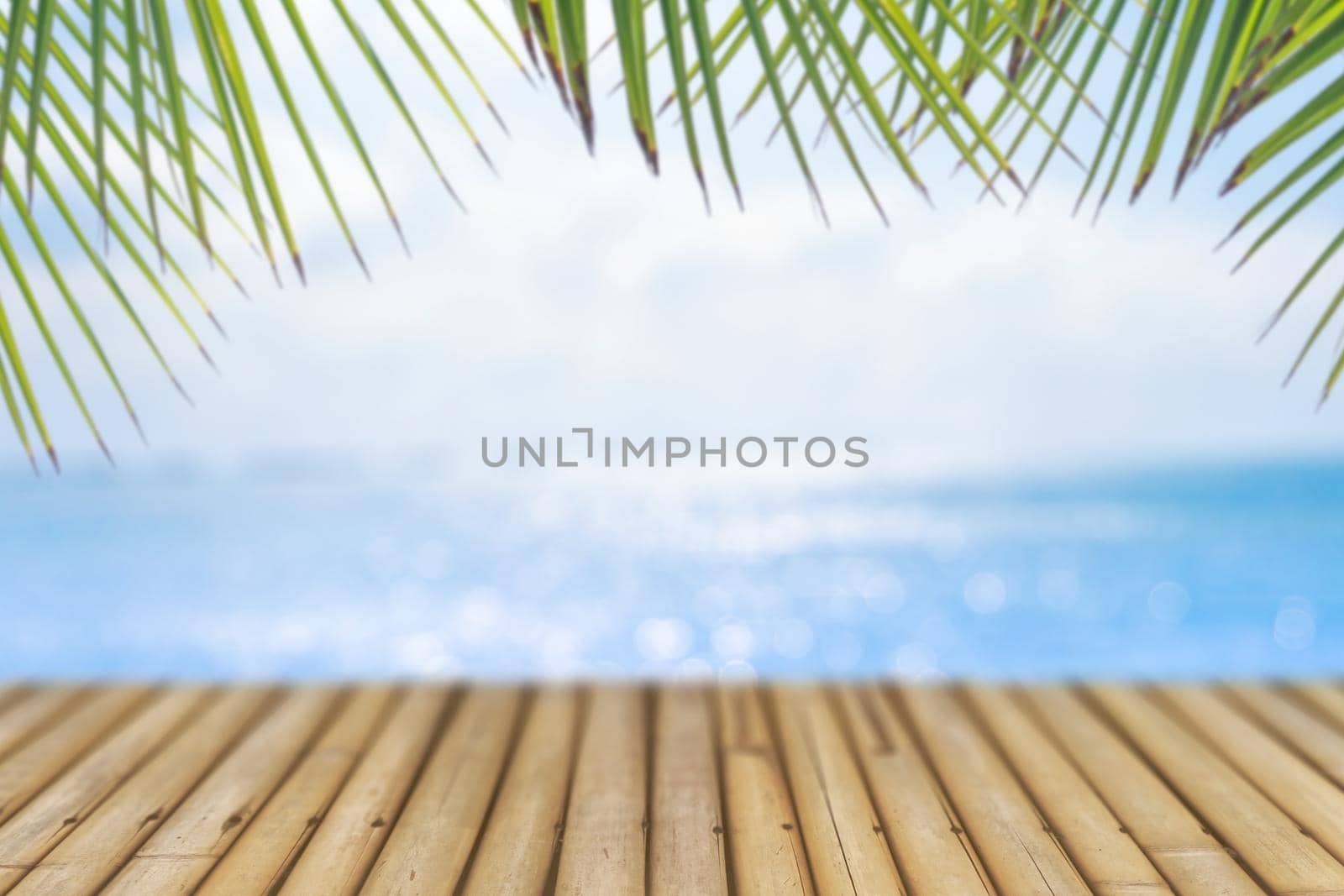 Selective focus of old wood table with blur beautiful beach for display your product.