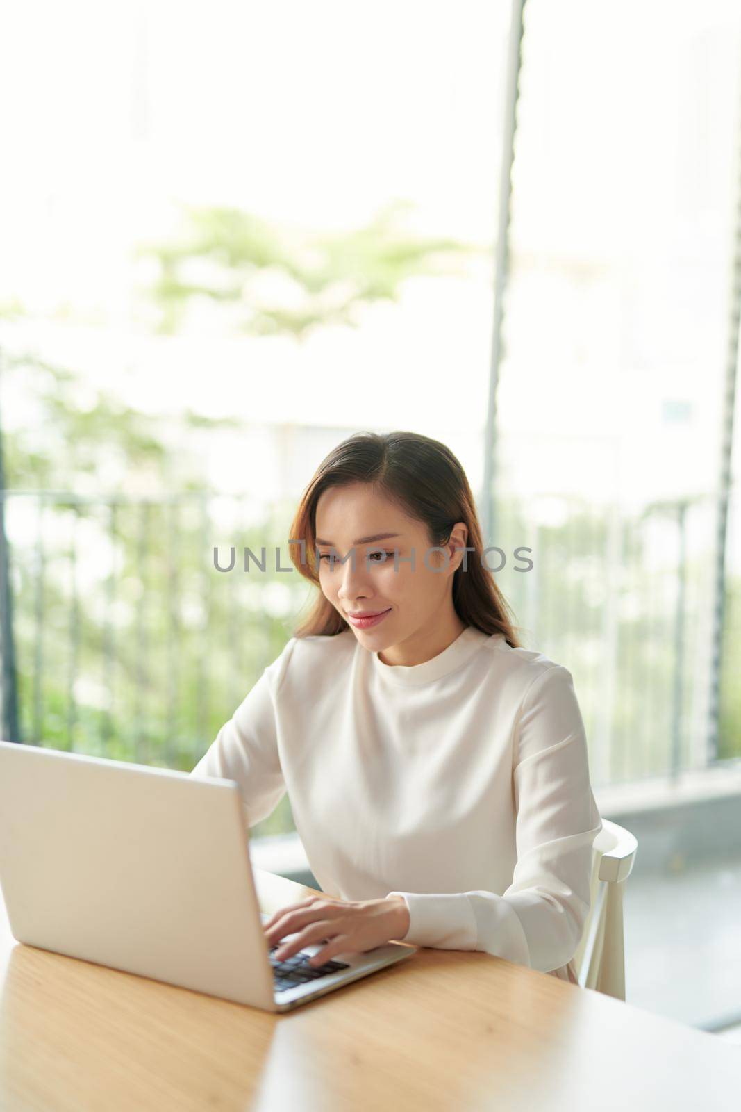 Beautiful asian businesswoman using a laptop computer by makidotvn