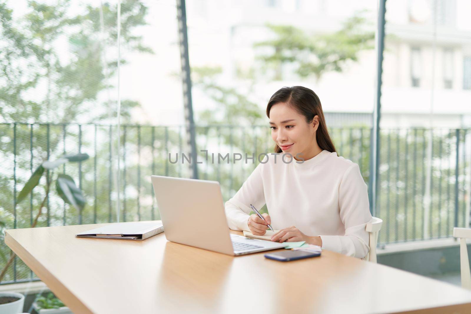 Beautiful business woman using a laptop computer by makidotvn