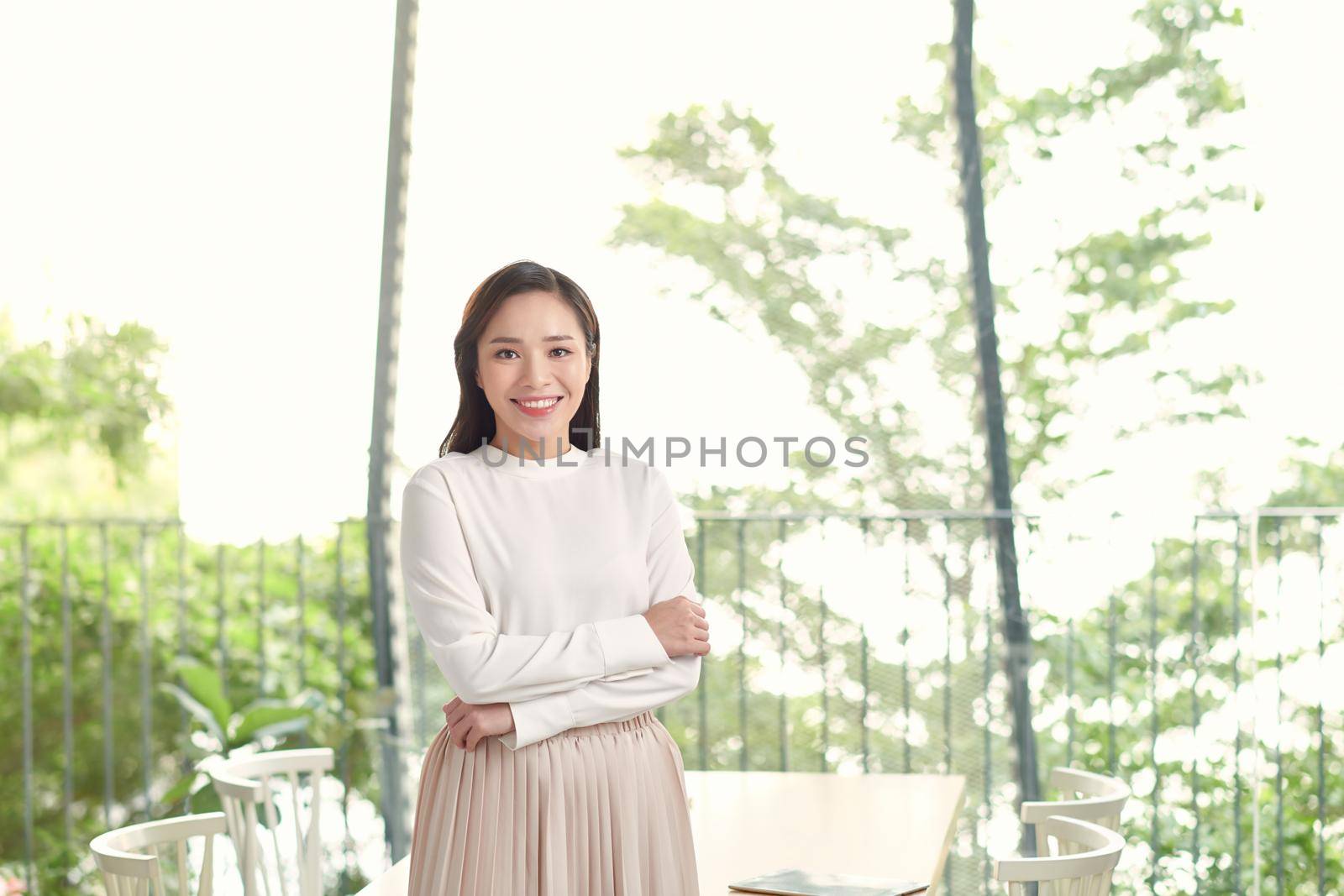 Young beautiful Asian business woman standing in office. by makidotvn