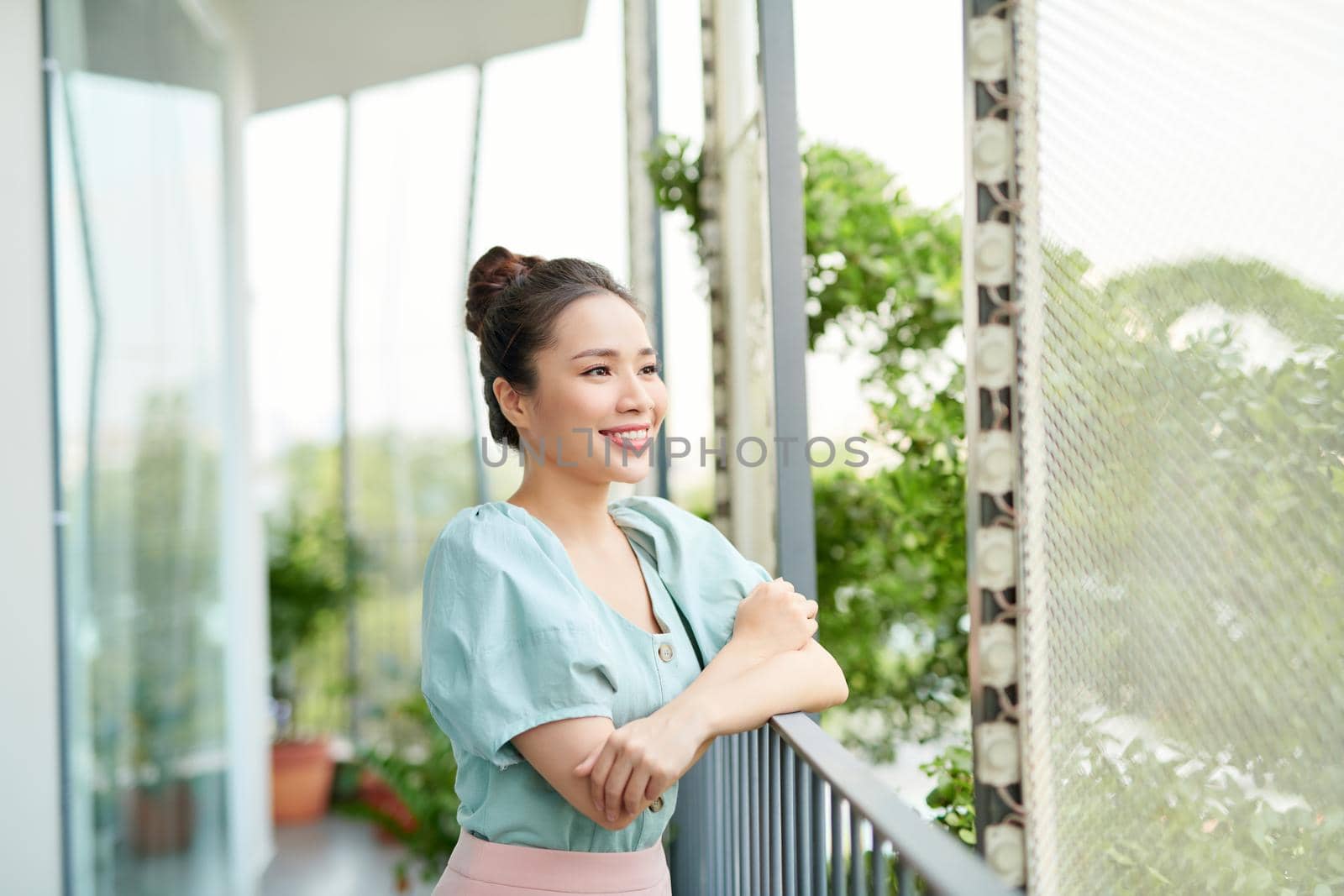 Portrait pretty girl looking the view on balcony. Relaxation.