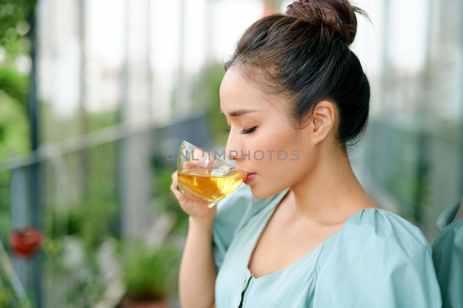 portrait of young woman on the balcony holding a cup of tea in the morning.