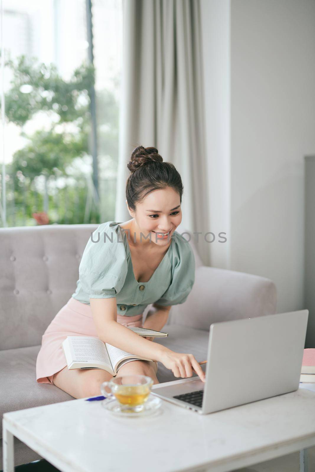 Smiling woman sitting thinking in an office chair as she mulls over a new idea in her mind