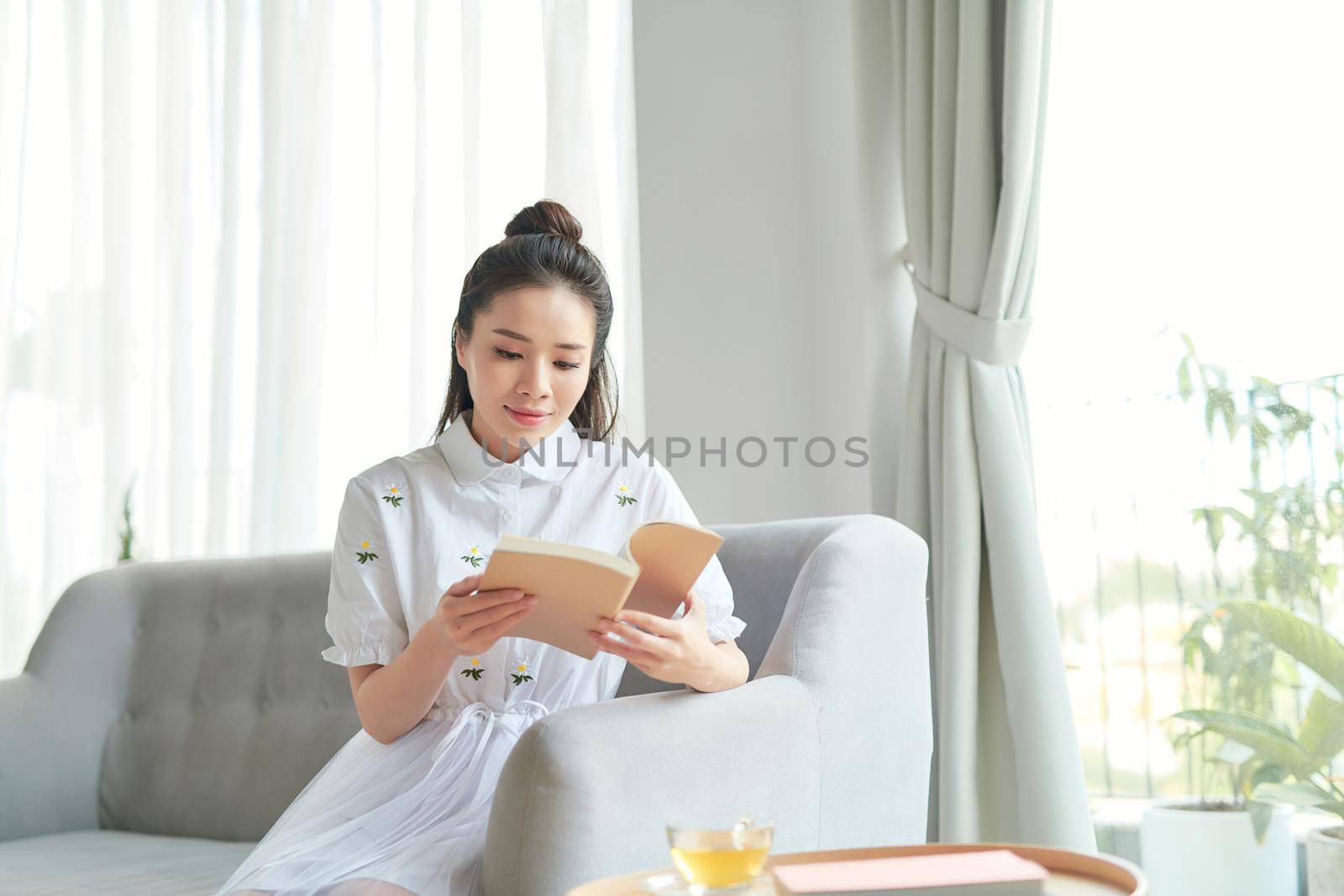 Girl reading an interesting book and smiling