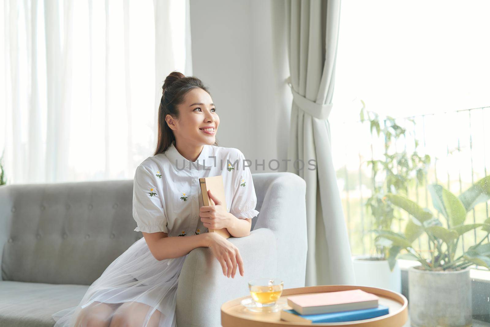 woman have relax at home with cup of tea and book 