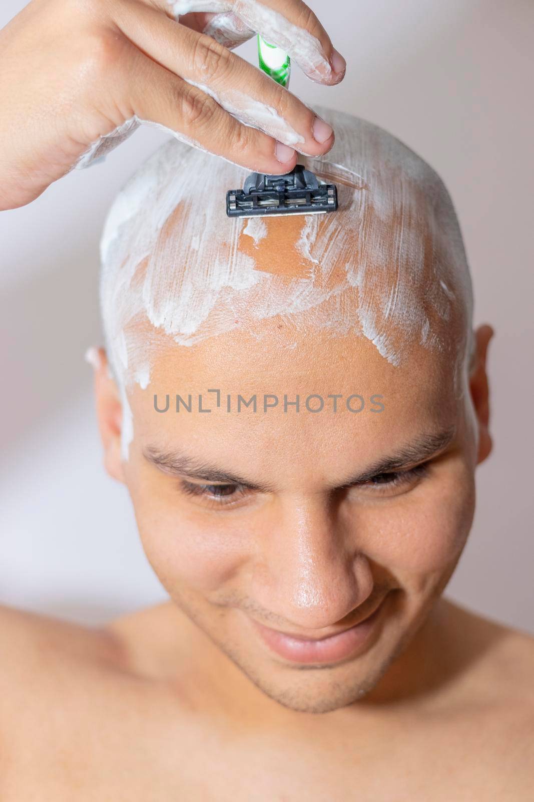 Man Shaving His Head Using White Foam