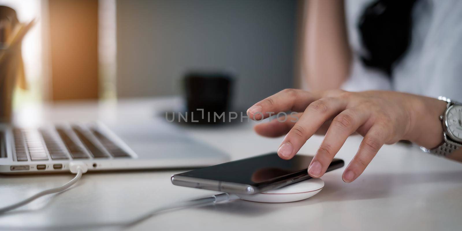 Business woman or accountant try to pick up the cell phone while client calling. Work From Home concept. by itchaznong