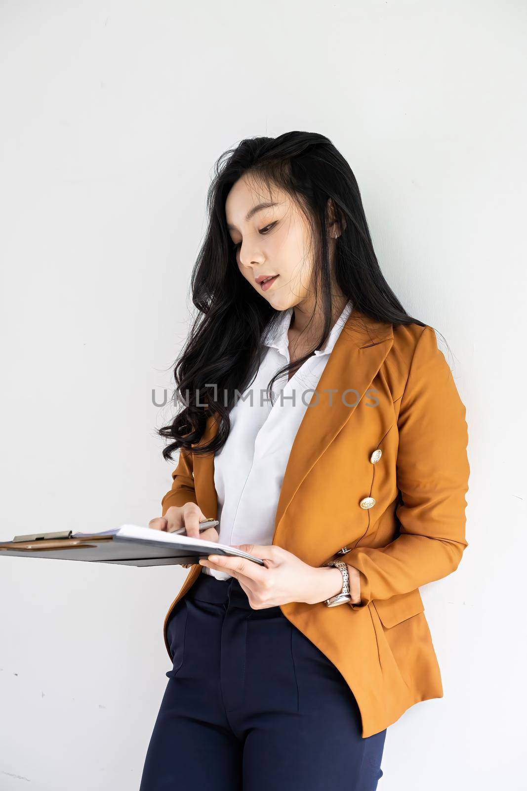 Portrait Asian Business or Accountant holding paperwork file. by itchaznong