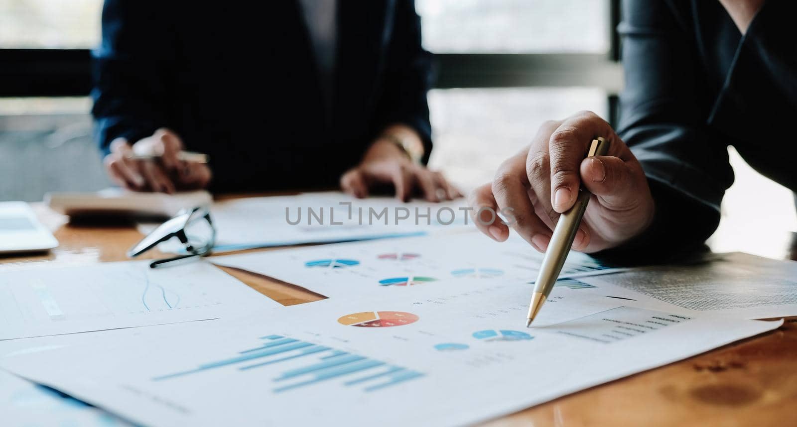 Business People Meeting Design Ideas Concept. Group of Investor diverse brainstorm and pointing at laptop computer on wooden desk.
