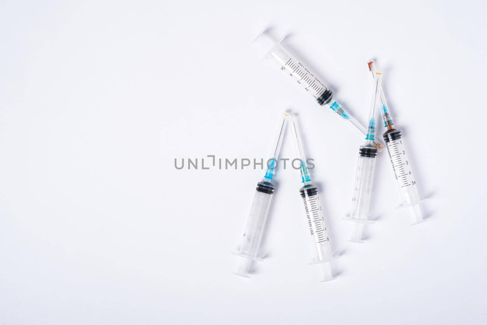 Dirty used plastic syringes, isolated with copy space