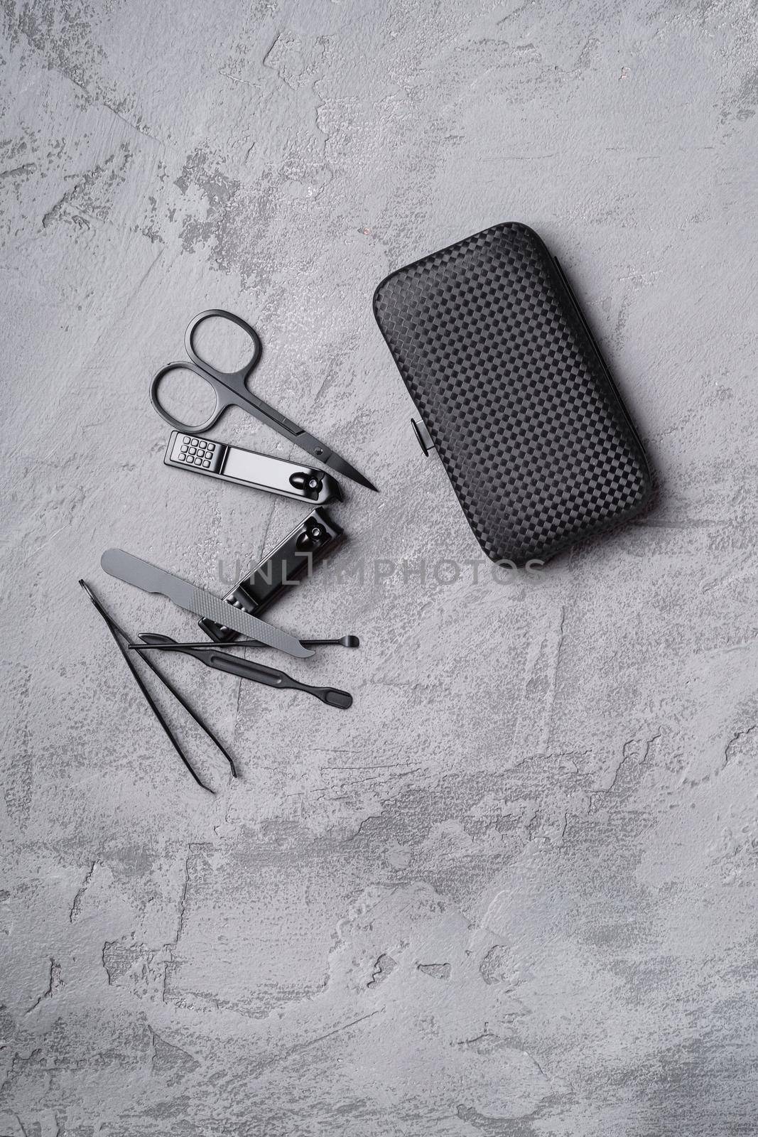 Set of manicure, pedicure tools and accessories with case, stone concrete background, top view by Frostroomhead
