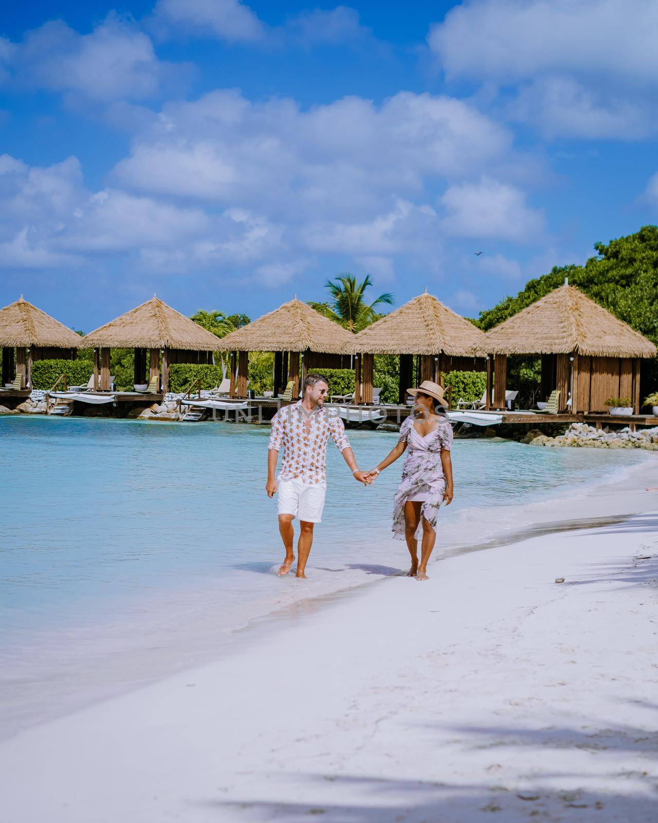 Aruba March 2021 beach with pink flamingos at the beach, Aruba , couple of men and woman on luxury vacation men and woman on honeymoon at the beach Aruba