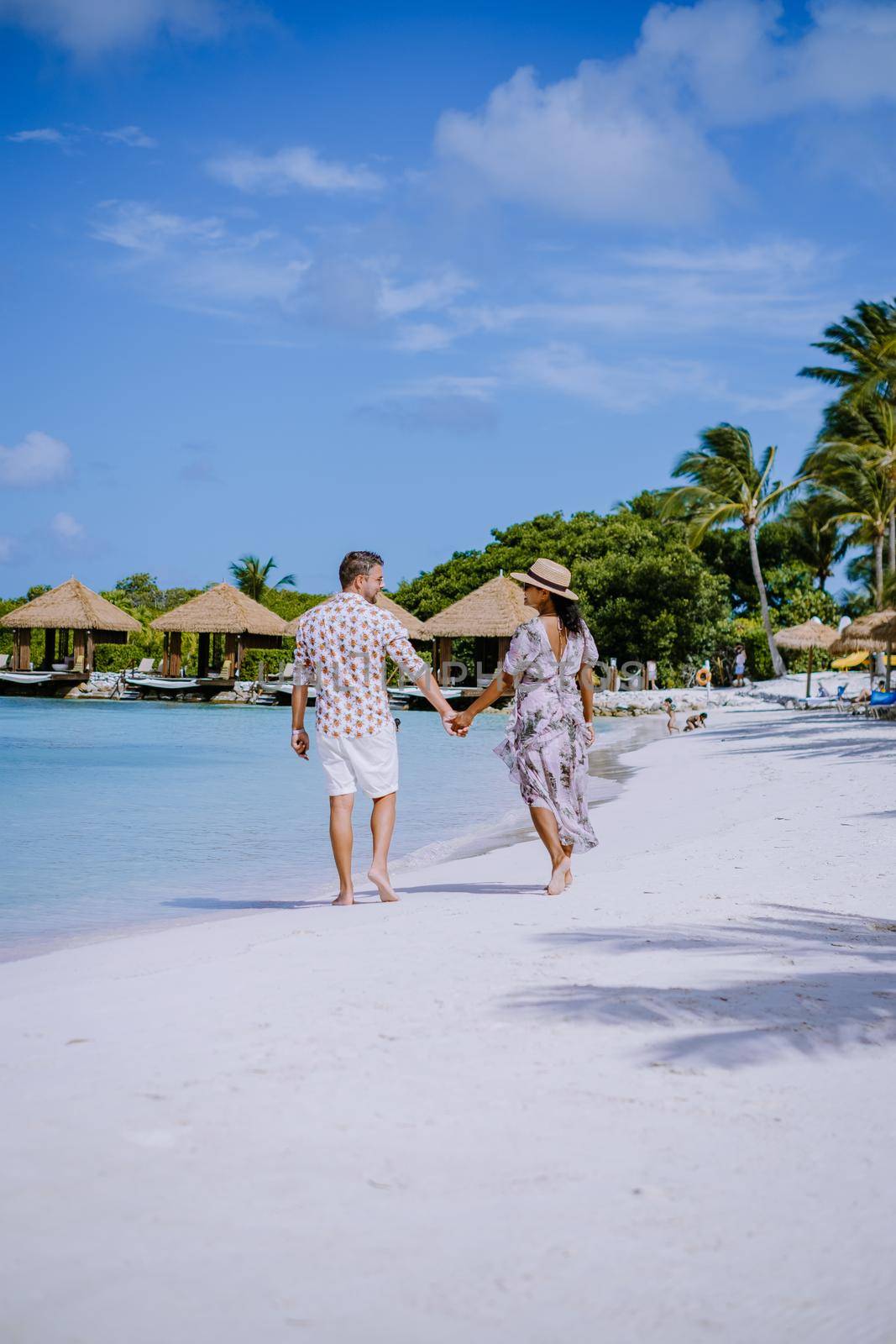 Aruba March 2021 beach with pink flamingos at the beach, Aruba , couple of men and woman on luxury vacation men and woman on honeymoon at the beach Aruba