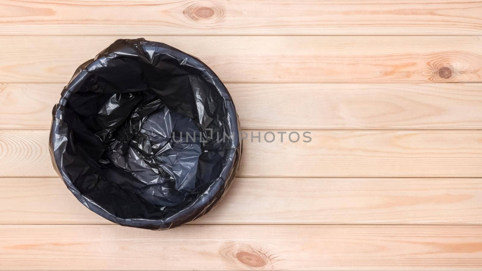 Trash Can Top View. Empty Garbage Bin Banner. Black Bag in a Trash Can. Rubbish Bin. Empty Bin on Wooden Floor. Waste Bin on Wooden Background. Waste Can with Plastic Package. Banner Garbage Basket by synel