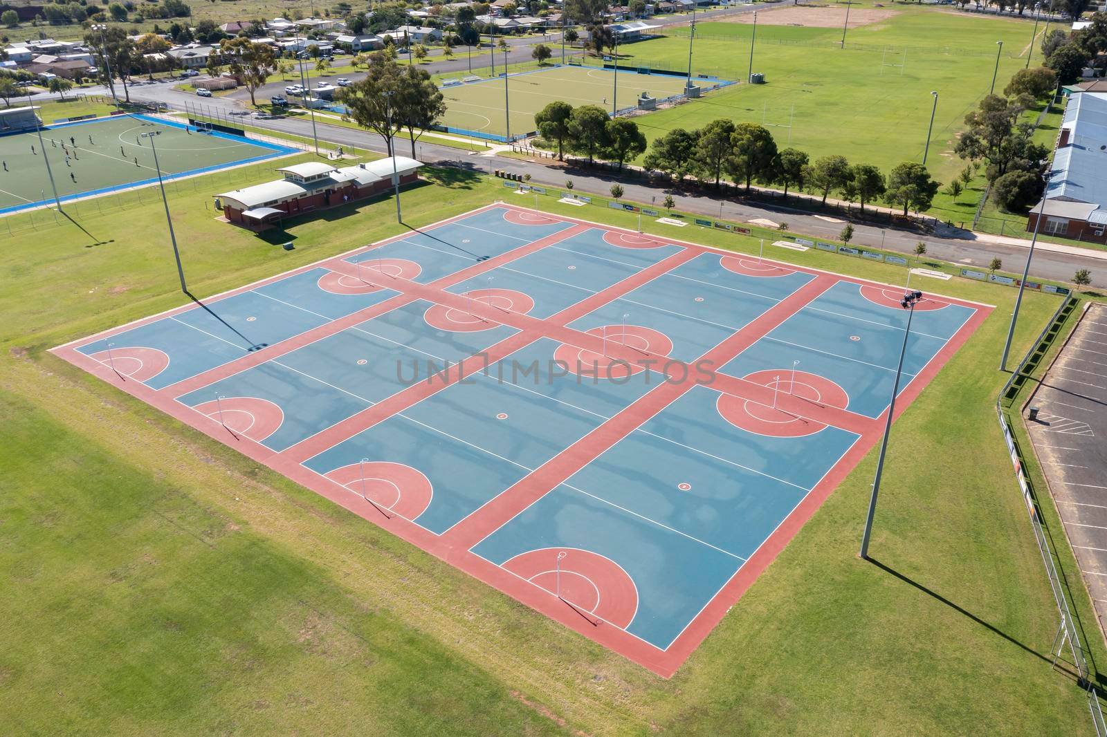 Drone aerial photograph of colourful netball courts and large sports fields in regional New South Wales in Australia