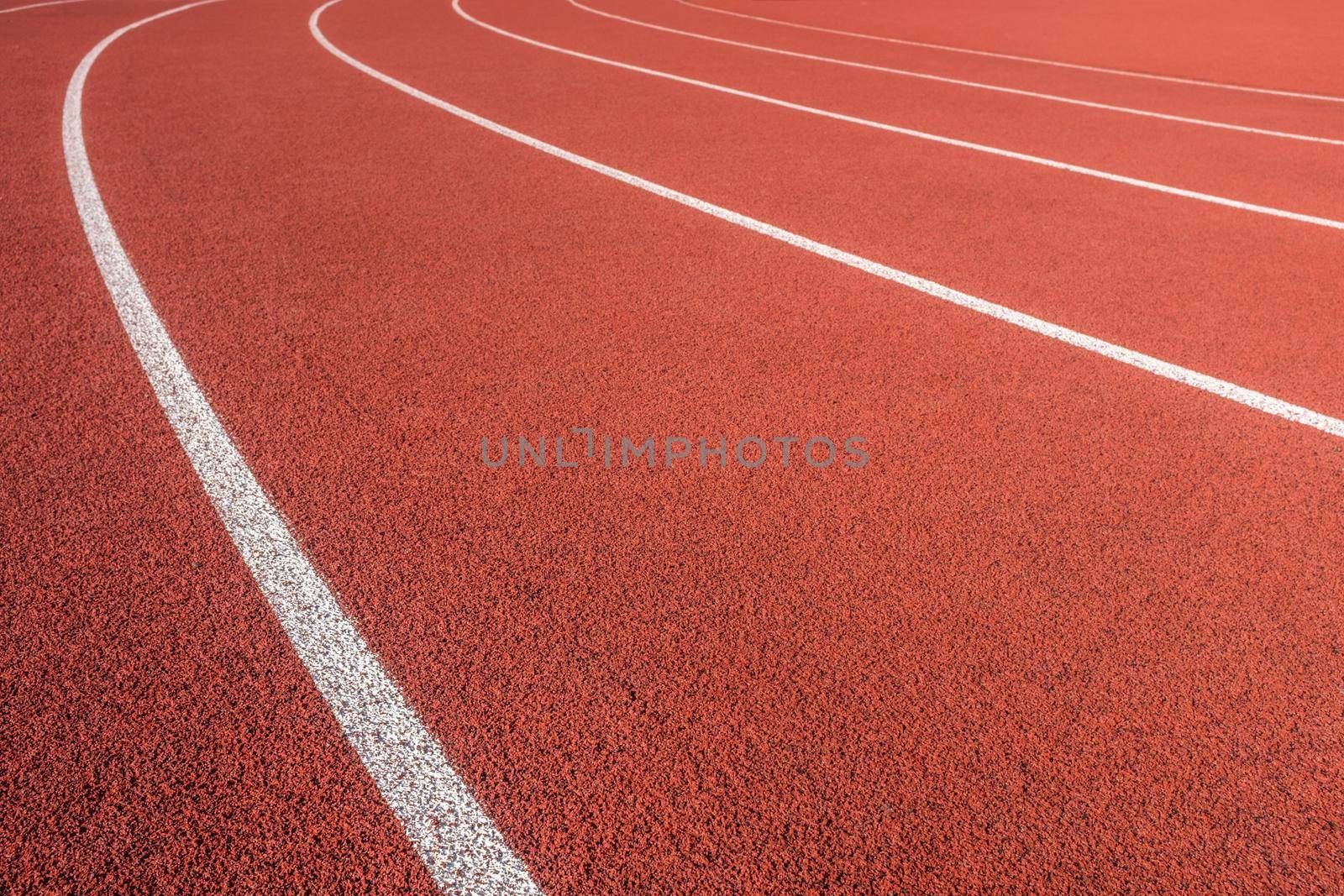 White Markings On A Red Athletic Race Track In A Sports Stadium